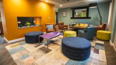 Photograph of a variety of different armchairs in a bright colourful social area