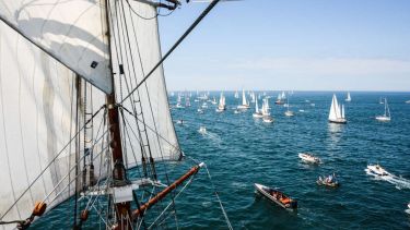 Yachts sailing away at the start of the Golden Globe Race 22022