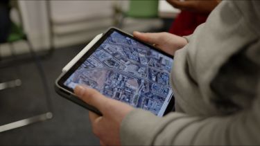 Holding a ipad with USP imagery