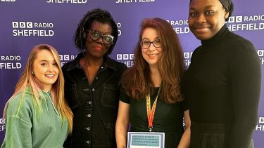 Four women standing in front of a board that reads BBC Radio Sheffield
