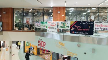 Inside the students union, with SU election banners hanging on the balcony 