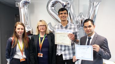 Photograph of Aiman with colleagues at Inspiring Student Workers awards