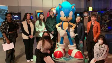 Group of student posing in front of sonic 