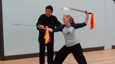 Deborah McCall training with double broadsword with Grandmaster Chen Xiao Wang