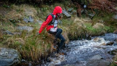 Jennie about to cross a small river