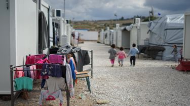 Photo of children walking through a refuge camp