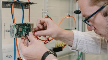 Photo of researcher Dr Michael Farnsworth working in the Digital Manufacturing Lab