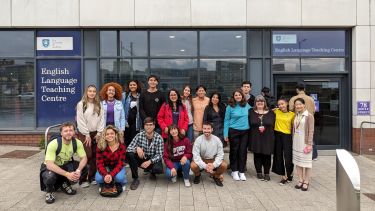 A picture of 18 Santander Scholarship students and ELTC staff members stood in front of the main entrance to the English Language Teaching Centre building.