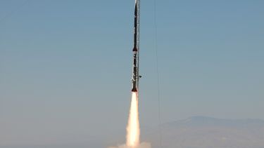 Photo of Karman Alpha accelerating along the launch rail shortly after launch