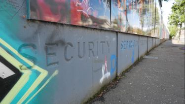 Peace wall in Northern Ireland with the word 'security' engraved into the brick