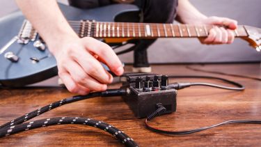 Photograph of guitarist using guitar pedal