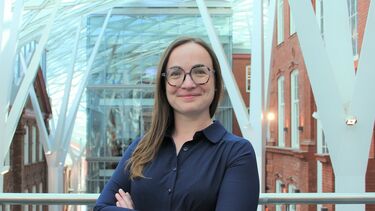 Woman in dark blue shirt with glasses