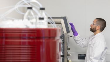 Researcher using lab equipment in the Gene Therapy Innovation and Manufacturing Centre