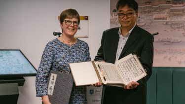 Anna Clemens and Lihwan Kim hold Korean books