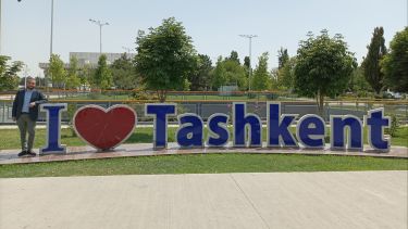 Frank Maracchione stood next to a big sign reading 'I Love Tashkent'