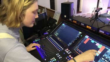 Molly operating live sound desk 