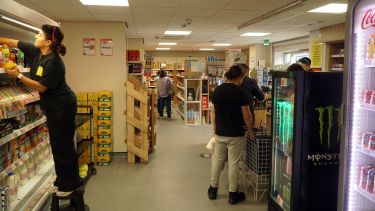 A girl stocking a fridge in a store