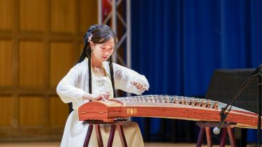 Lingxi Zang performs on the guzheng
