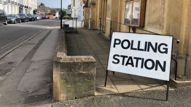 A wide shot of a polling sign