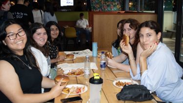 Students at a table in Bar One enjoying food and drinks