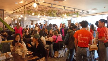 A busy scene in Coffee Revolution, packed full with international students and ambassadors