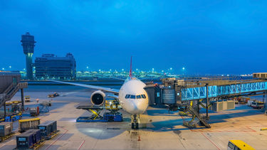 A plane seen from the gate being boarded before take-off