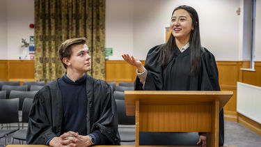 Two students undertaking a moot in the Moot Court