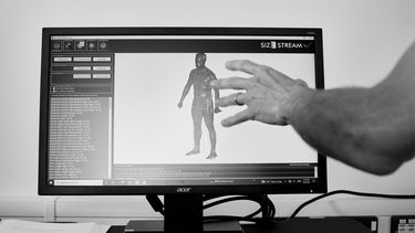 A hand hovering over a computerised representation of a person