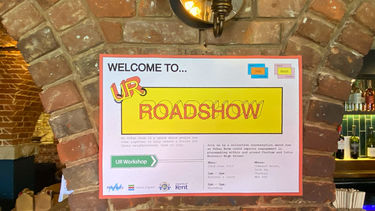 Urban Rooms Roadshow poster, most of which is unreadable apart from "welcome to U R roadshow".