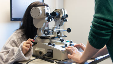 Ophthalmology students using clinical equipment