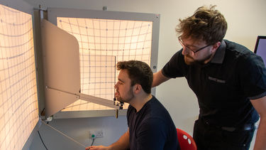 Two ophthalmology students using clinical equipment