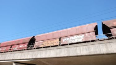 A freight train going over a bridge.