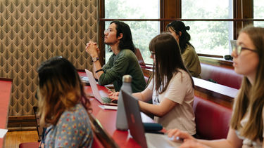 A photograph of students sitting in a lecture theatre.