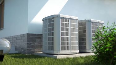 Heat Pump outside of a building with grass 