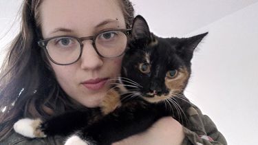 Image of Fiona holding a tortoiseshell cat 