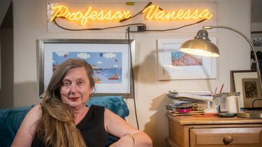 Professor Vanessa sat on a sofa 