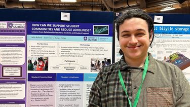 Milo Bullock smiling with his research poster