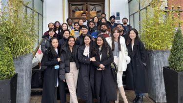 A group of MBA students stood outside the Royal Victoria hotel.