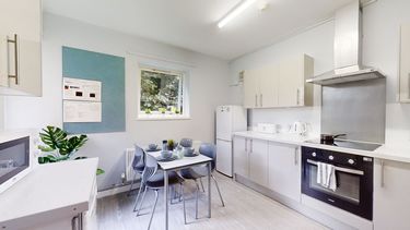 A kitchen with a table and four places set