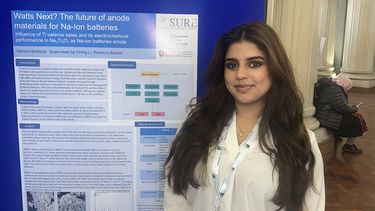 Photo of a student and their conference poster