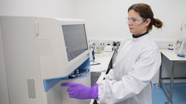 Eva Karyka, the GTIMC manufacturing lead using the metabolite analyser. It monitors the environment of the bioreactor and the health of the cells in it.