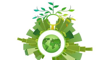 A green globe with city buildings growing around it