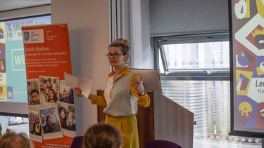 Louwerse speaking with Dutch orange banner in the background