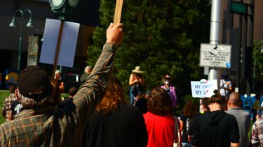 Striking worker holds placard aloft
