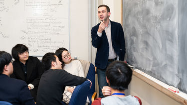 Academic teaching a room of students