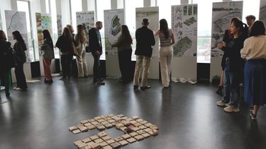 People viewing students design work at the 2024 exhibition in the arts tower