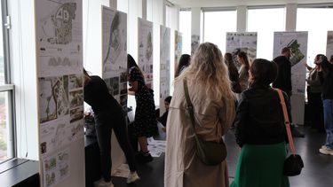 People viewing students design work at the 2024 exhibition in the arts tower