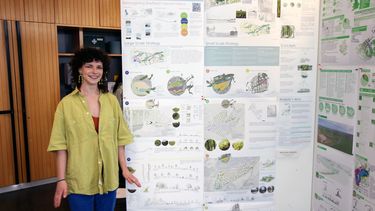 PGT Landscape student standing next to their work at the 2024 exhibition