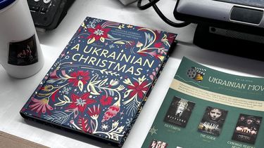 a table with a book called 'A Ukrainian Christmas and flyers of Ukrainian films