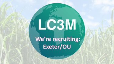 A logo on a turquoise planet, reading LC3M and We're recruiting: Exeter/OU, against a background of a field of crops